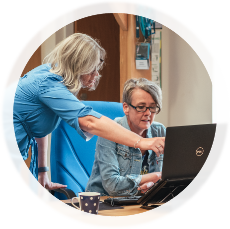 Photo of staff members looking at a computer screen