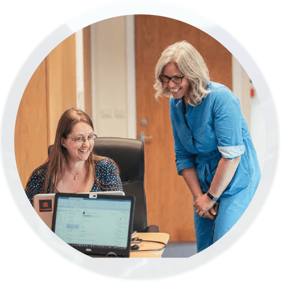 Photo of staff members looking at a computer screen